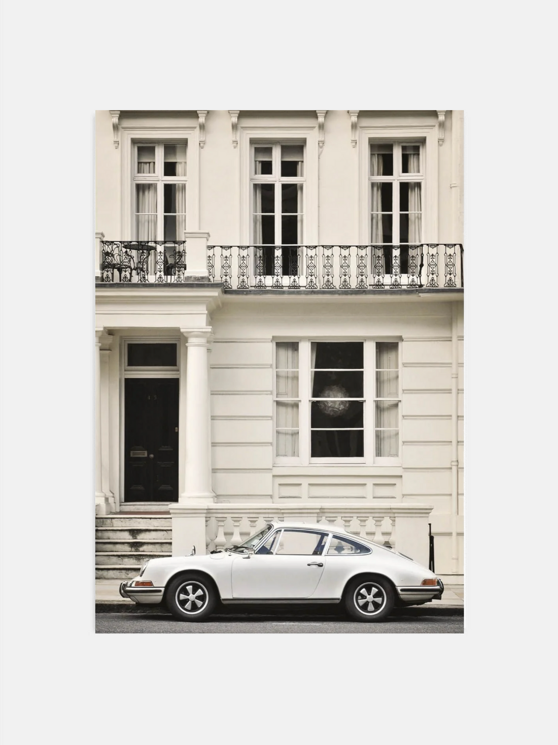 Porsche parked in front of city building