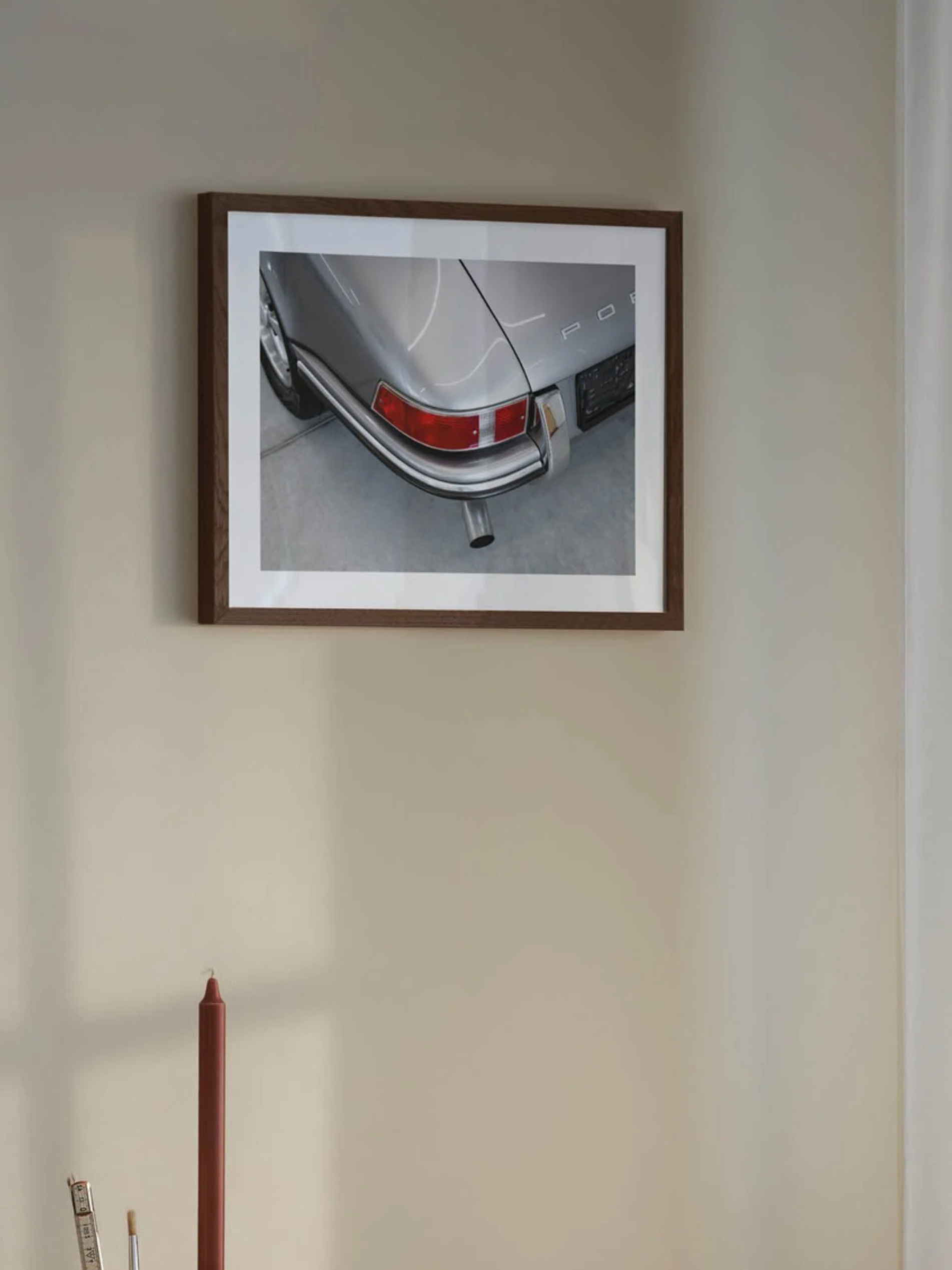 Vintage Porsche art print hanging on a modern living room wall