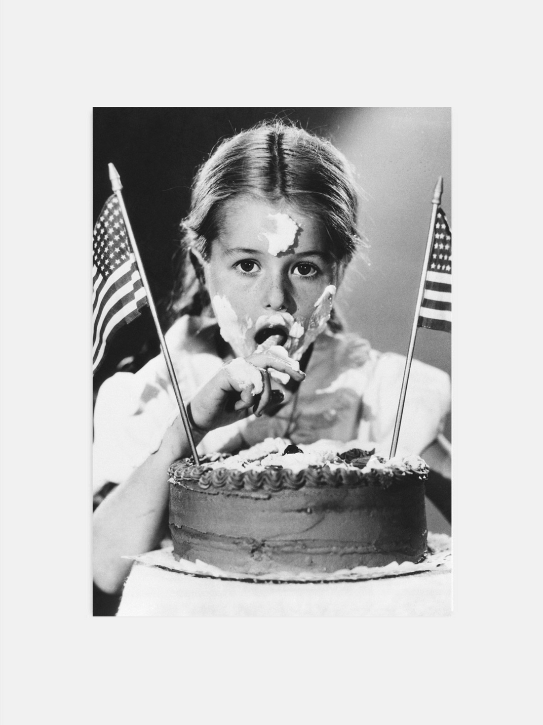 Girl eating 4th of July cake in vintage black and white