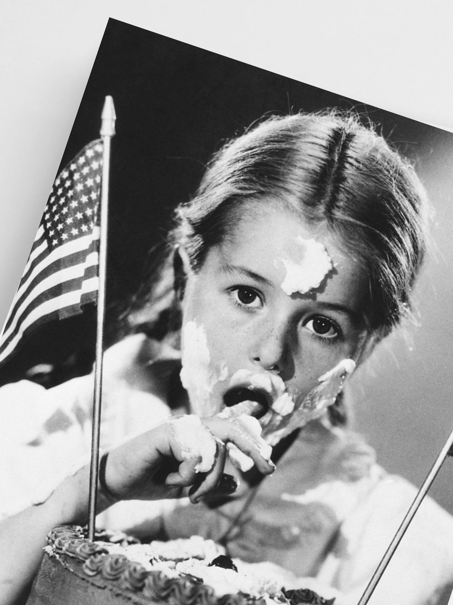 Black and white photo of a girl with an American flag, celebrating 4th of July