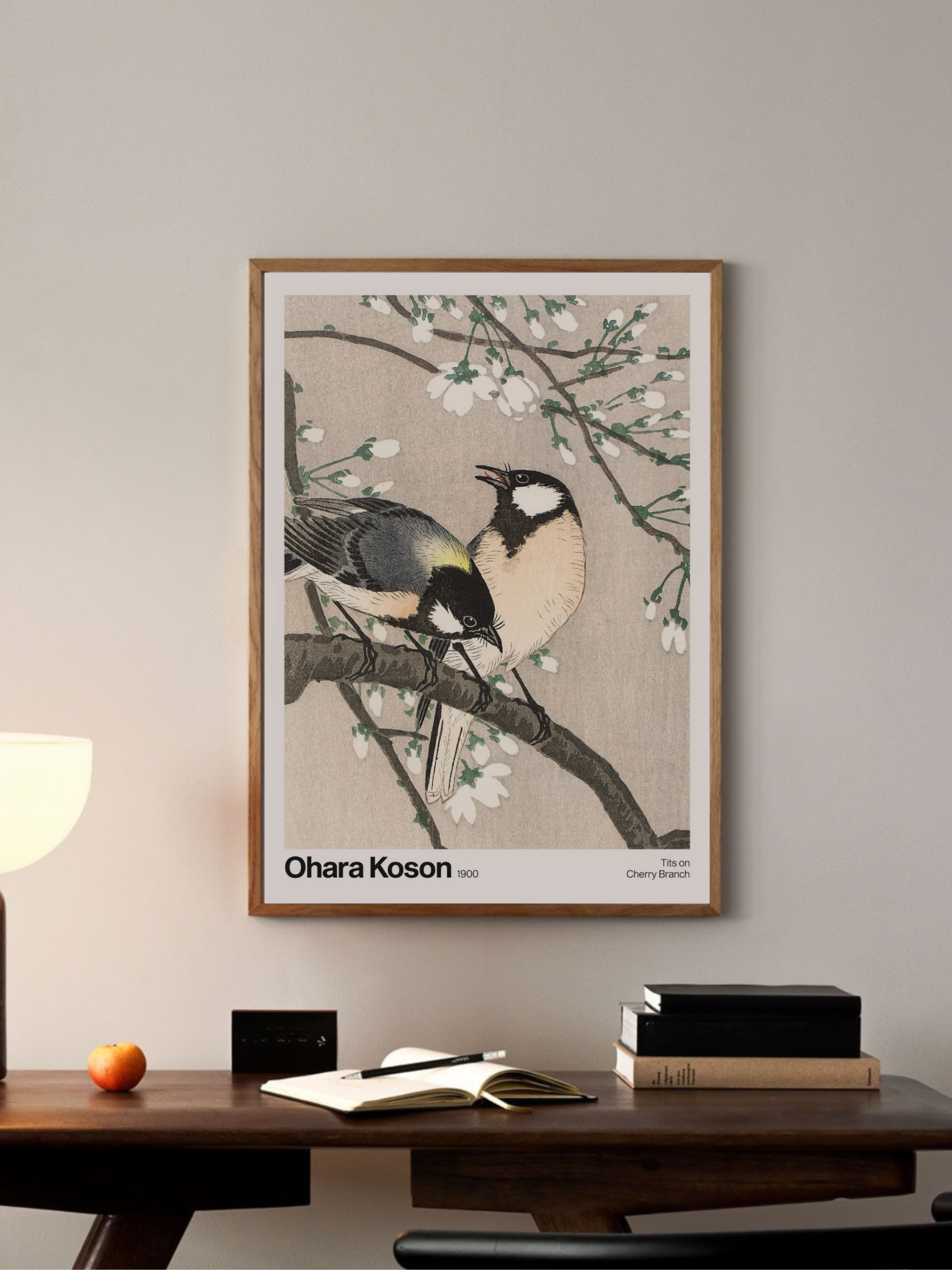Framed artwork of a Two birds resting on a cherry blossom branch  in a room setting.