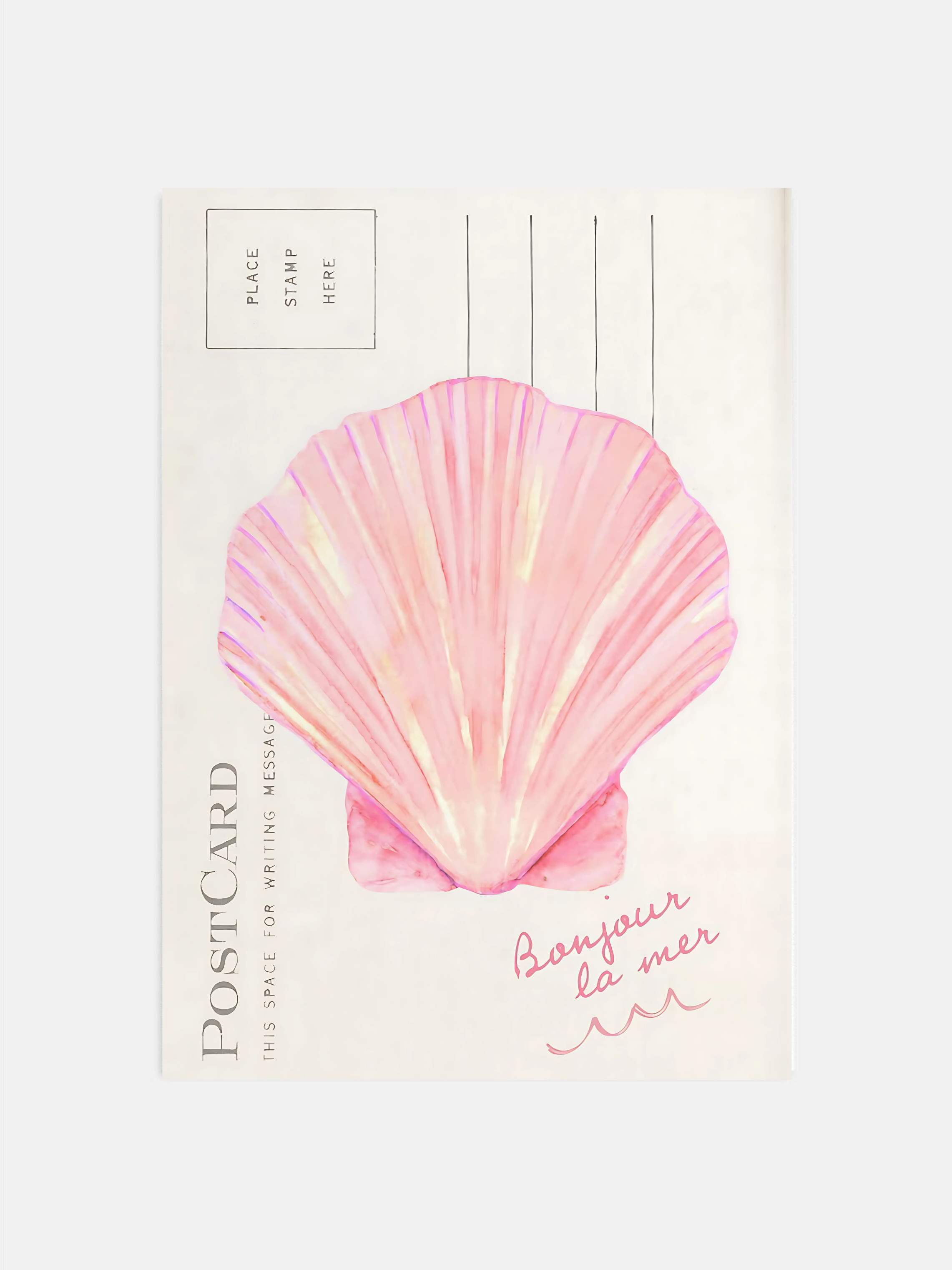 Coastal seashell wall art in pink hanging in a bright beachy bedroom.