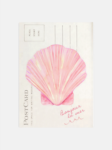 Coastal seashell wall art in pink hanging in a bright beachy bedroom.