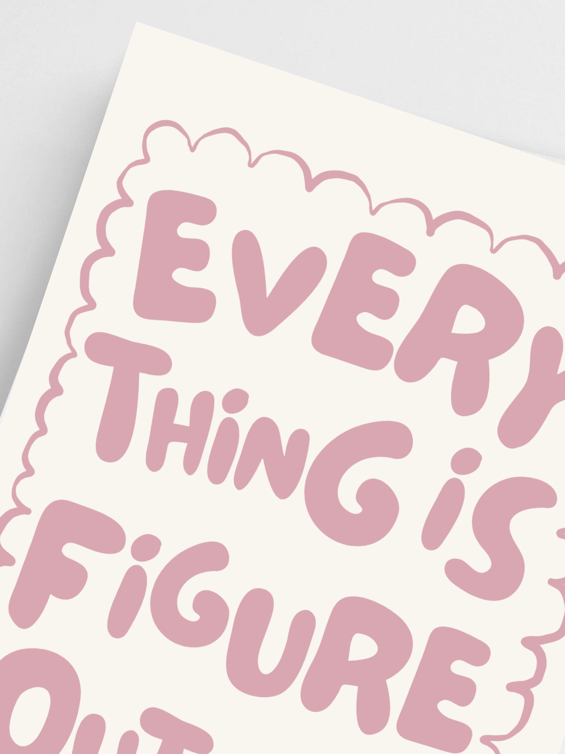 Close-up of motivational quote poster in soft pink and cream tones.