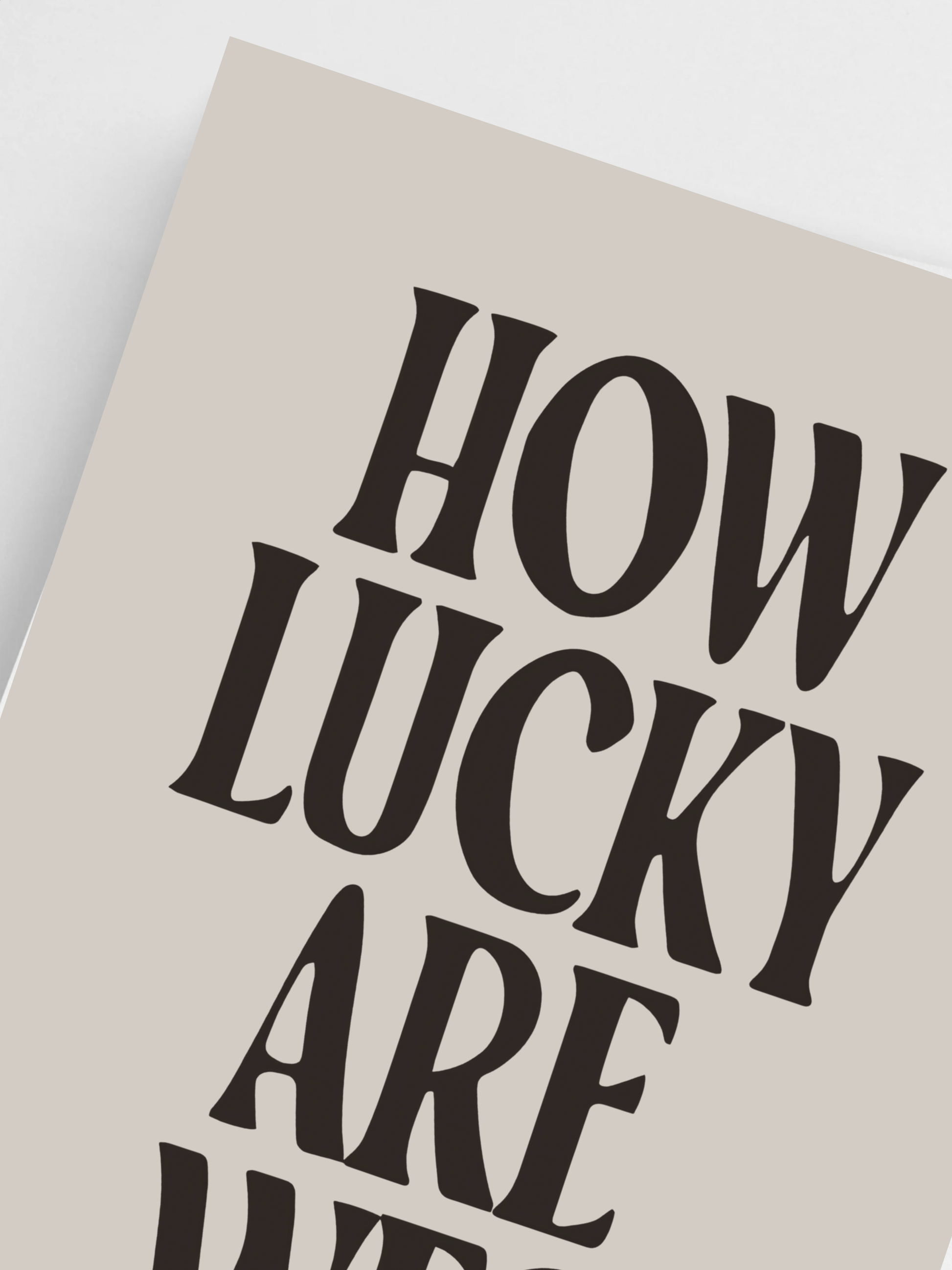 Beige Poster with black text 'HOW LUCKY ARE WE?' on a light gray background