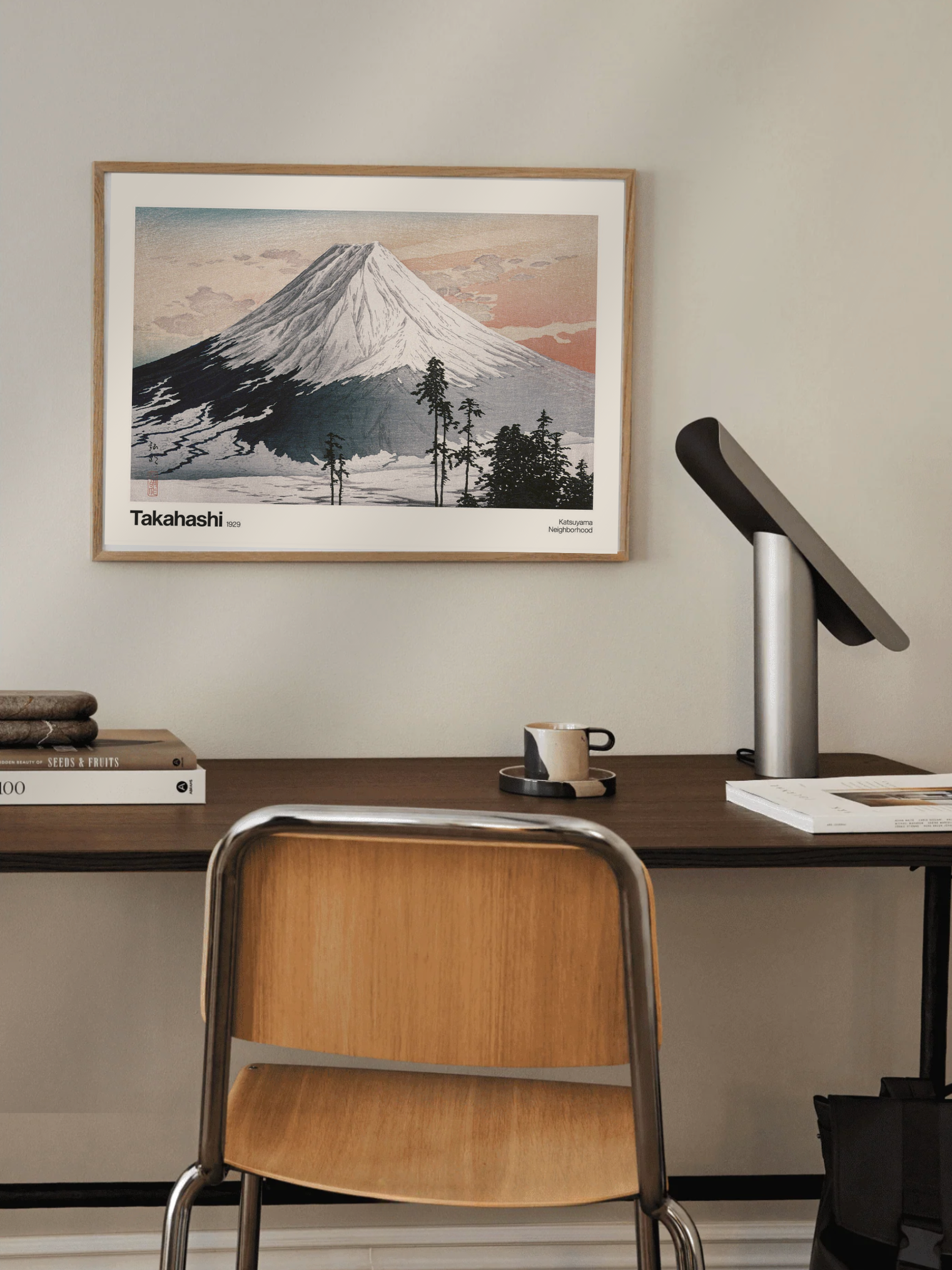 Desk setup with a framed picture of a Katsuyama mountain print in a cozy modern desk