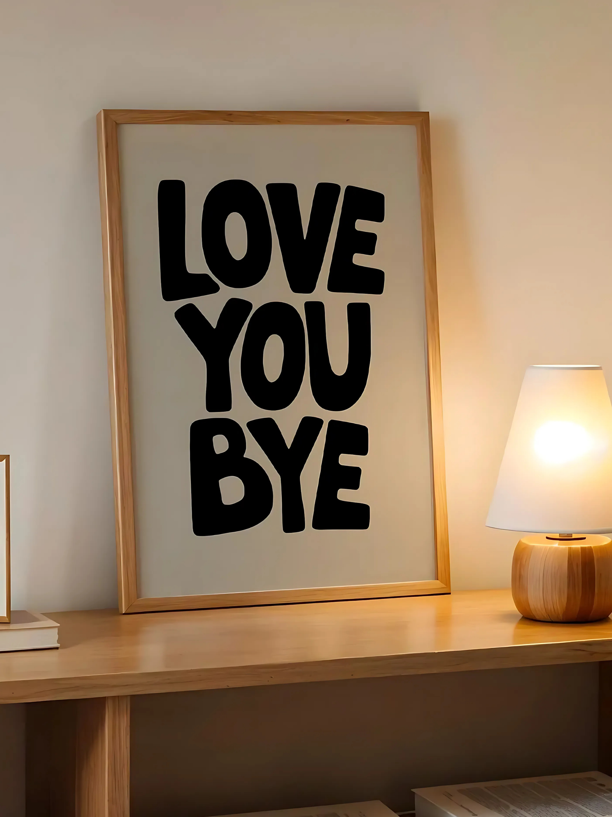 Minimalist LOVE YOU BYE poster adding a sweet touch to a cozy living room.