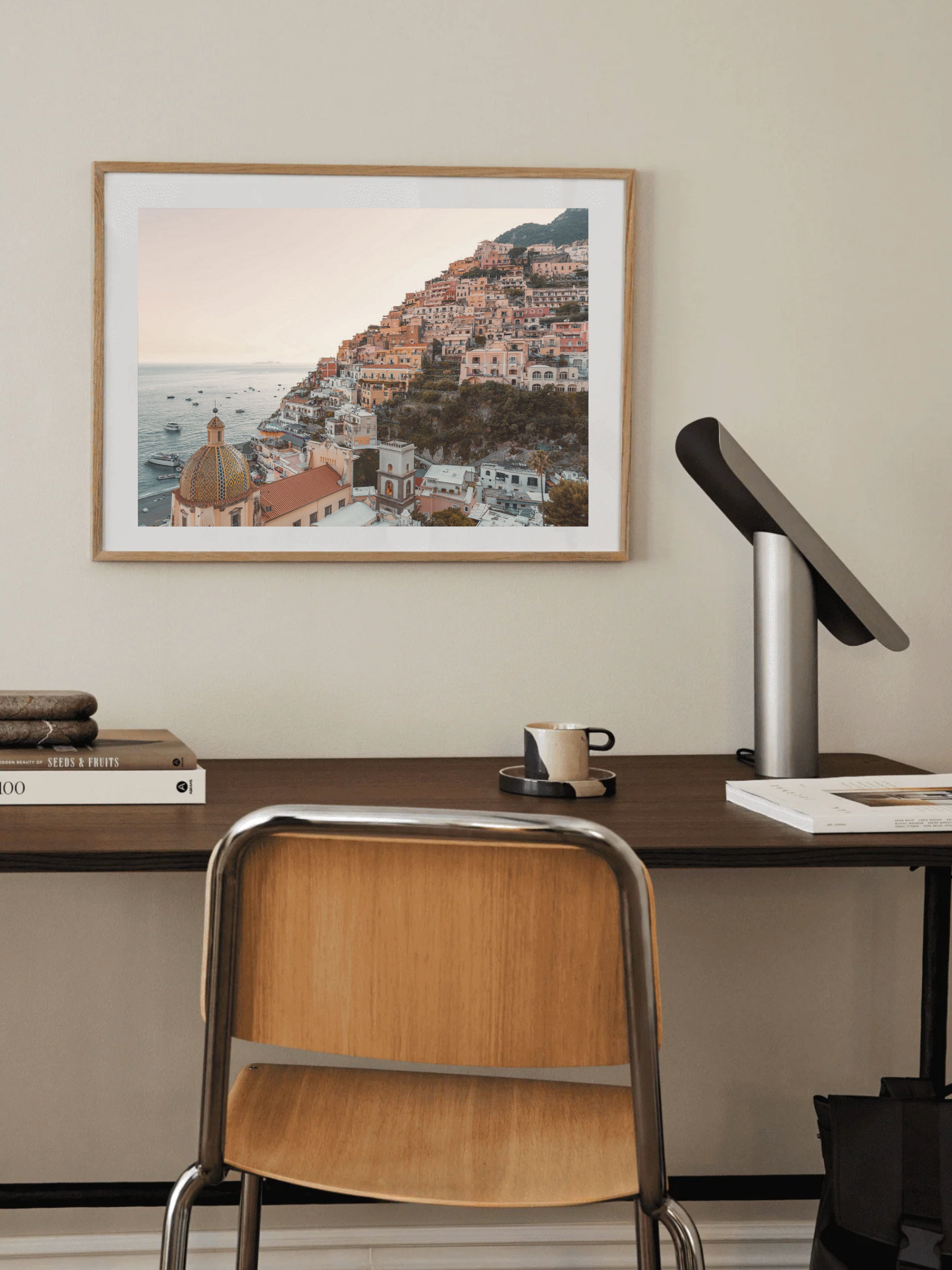 Amalfi Coast print framed in a light-toned interior above home desk