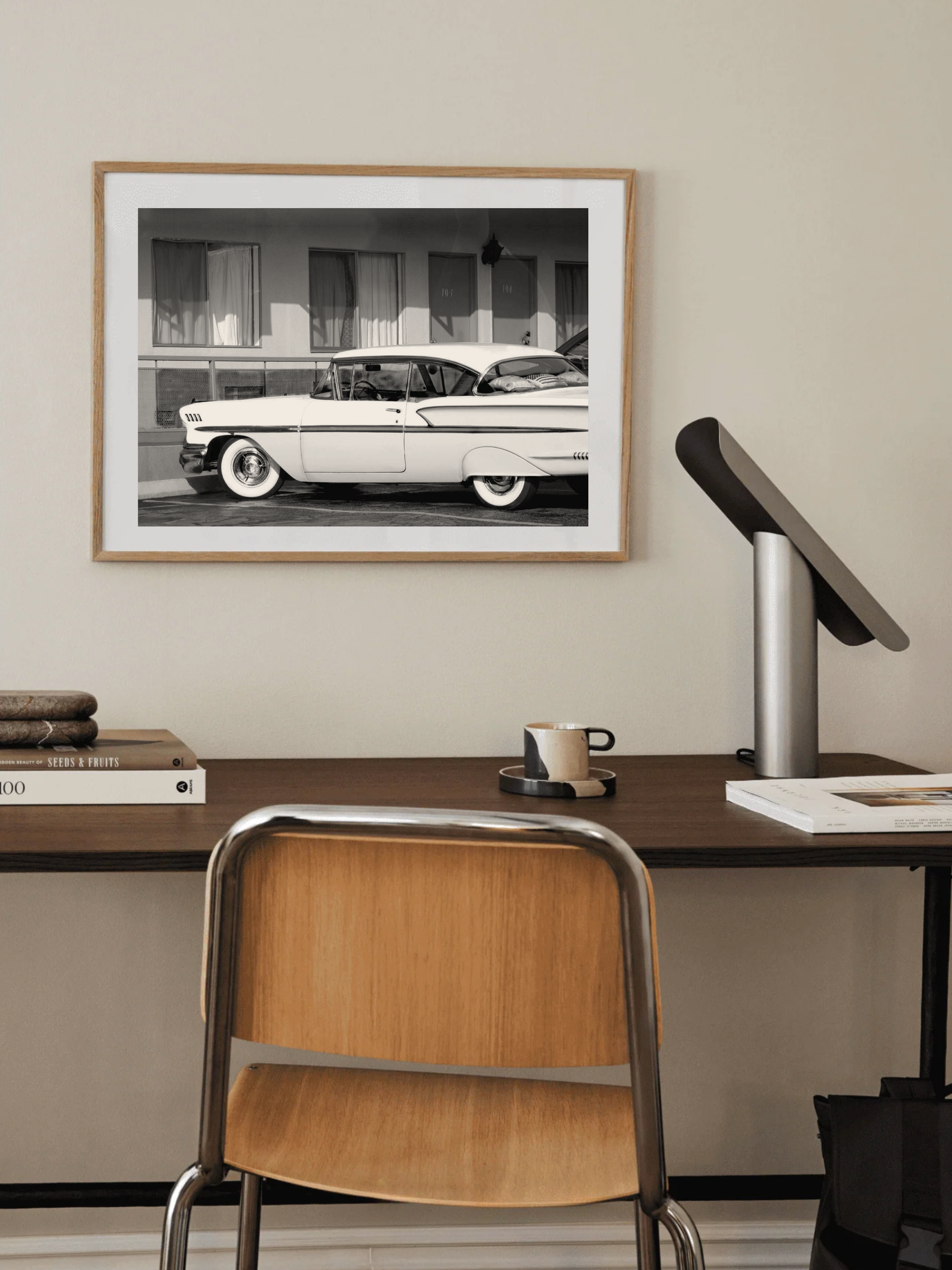 Retro motel poster hanging in an industrial-style interior above home desk