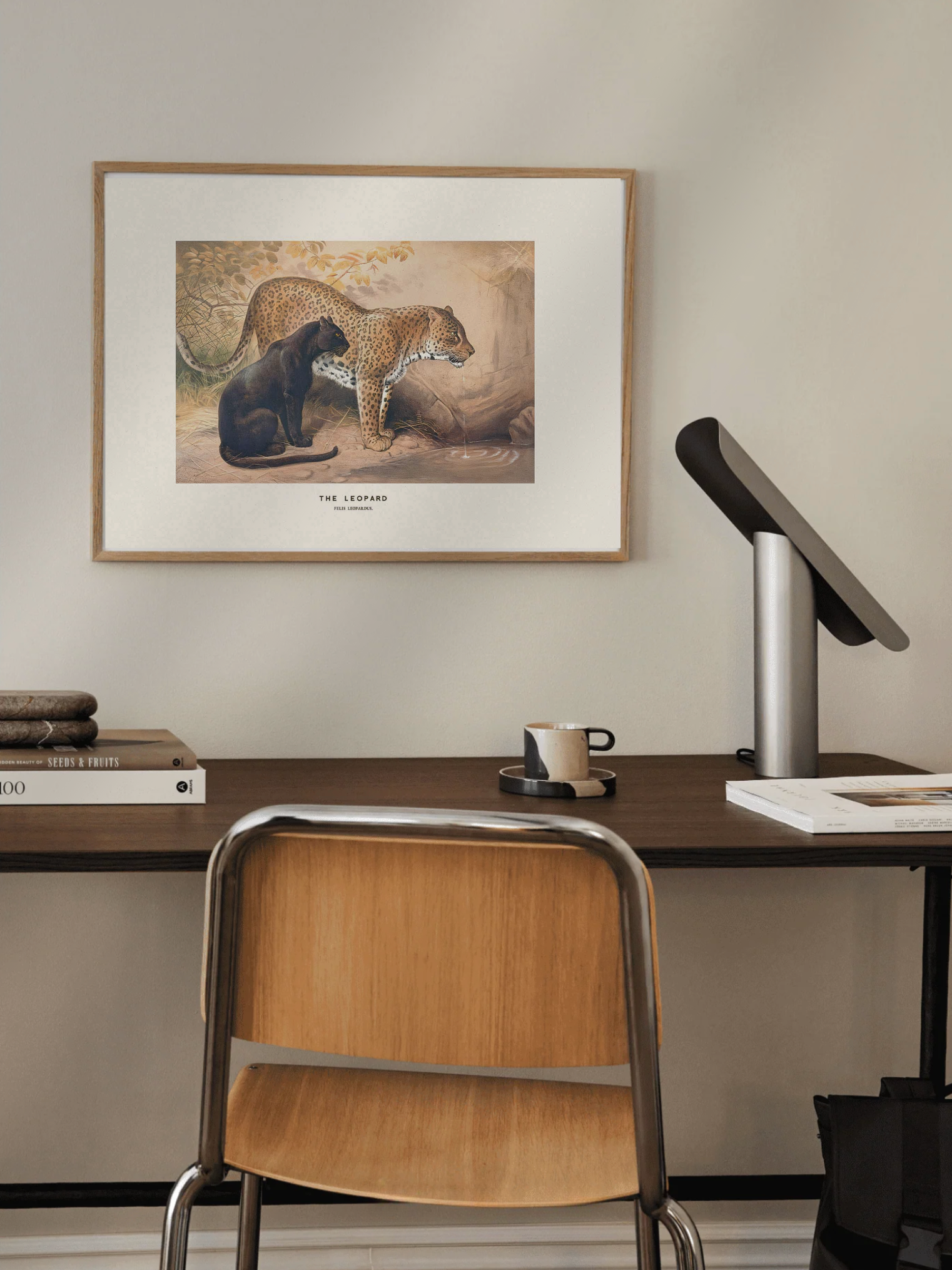 Home office with a desk, chair, and framed artwork on the wall.