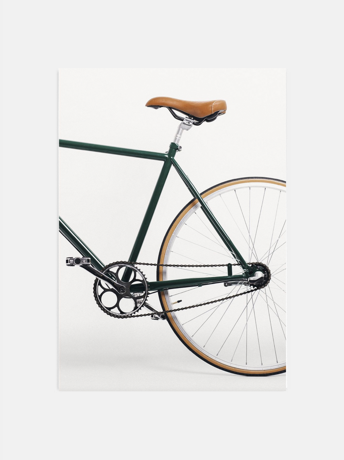Green bicycle with a brown seat on a white background