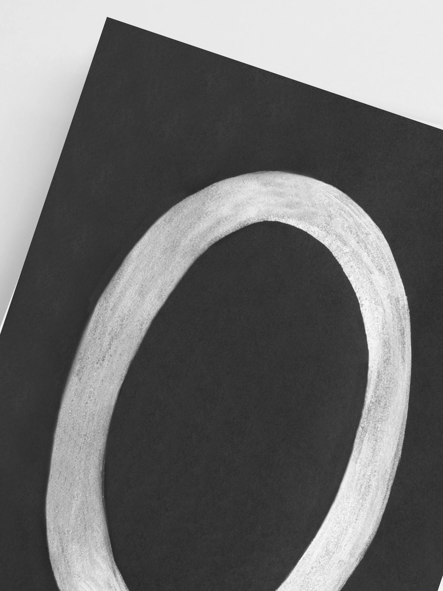 Black poster with a white circular object on a light gray background