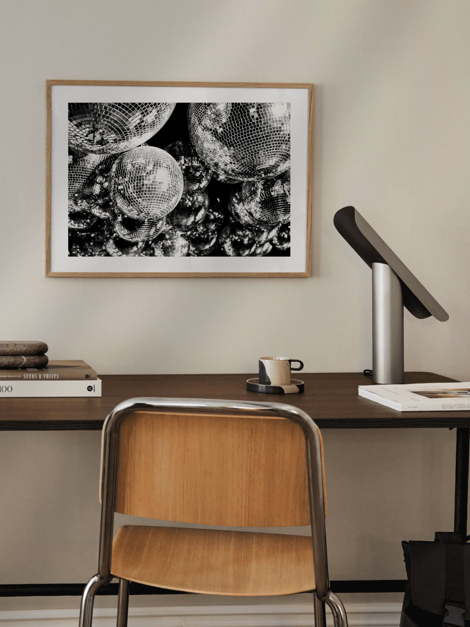 Nightlife glamour poster in black & white Framed black and white artwork above a desk with a chair and lamp.