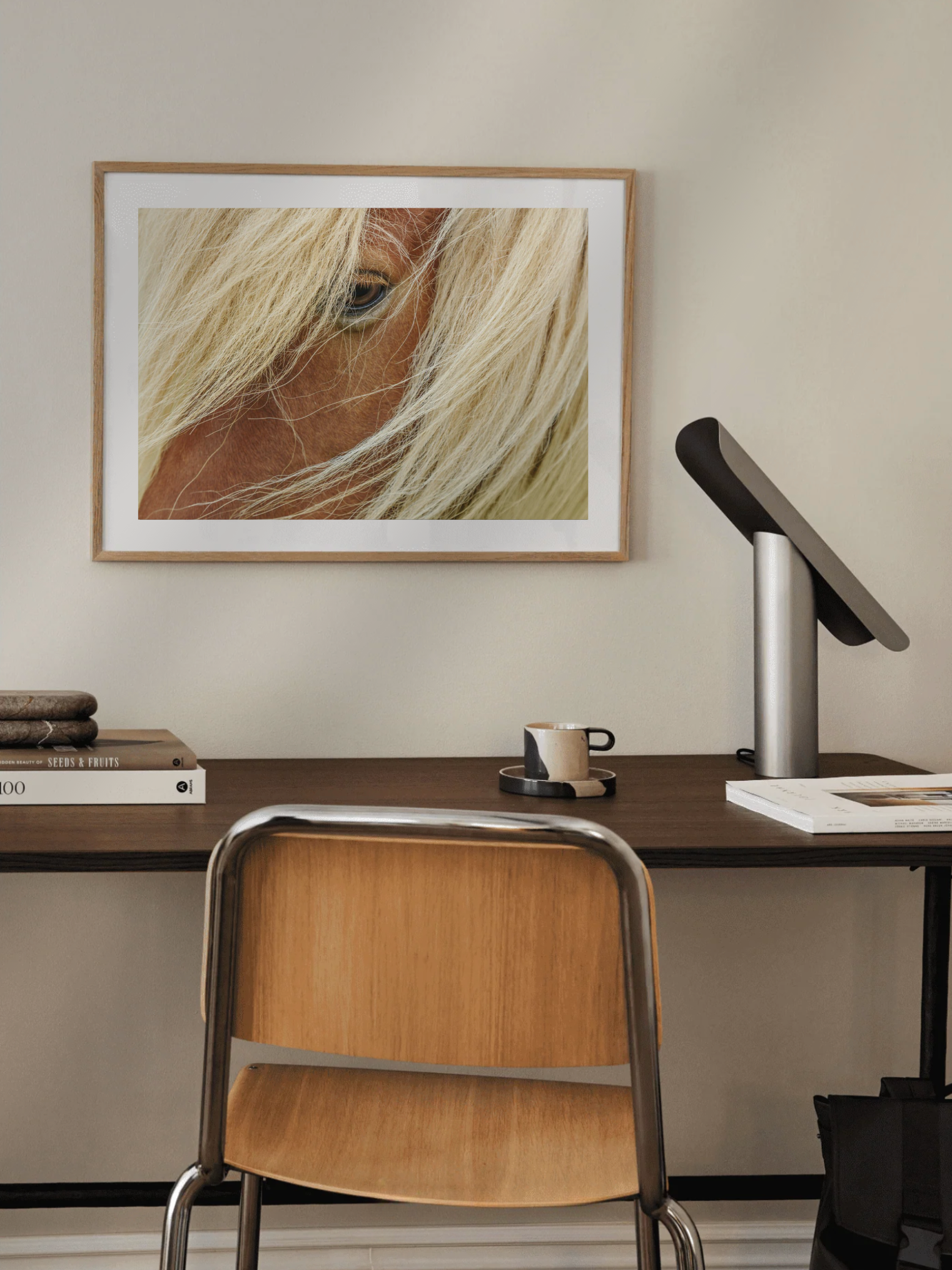 Home office with a desk, chair, and framed picture of a horse's face on the wall.