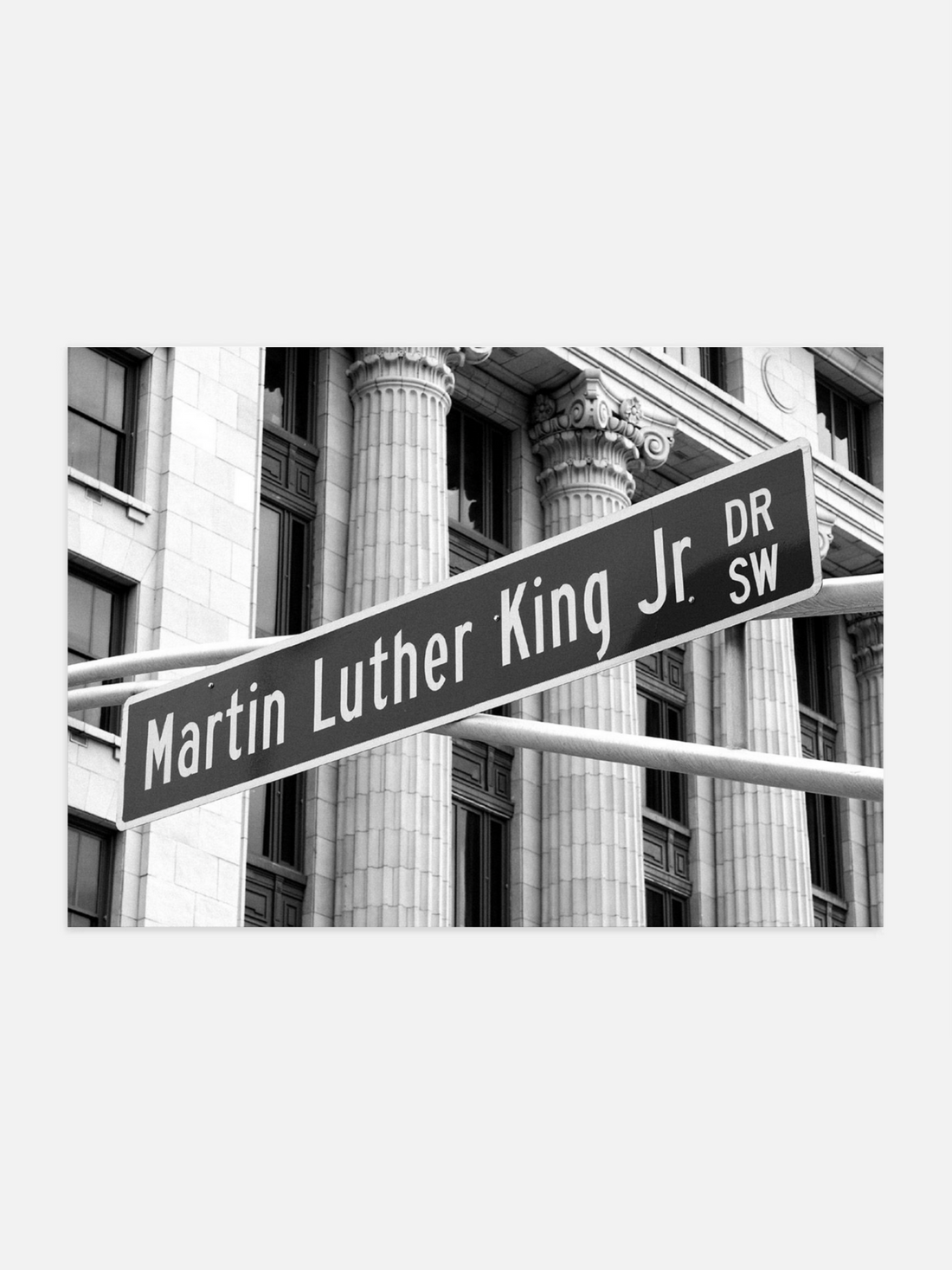 Street sign for Martin Luther King Jr. Drive SW in front of a building with columns.