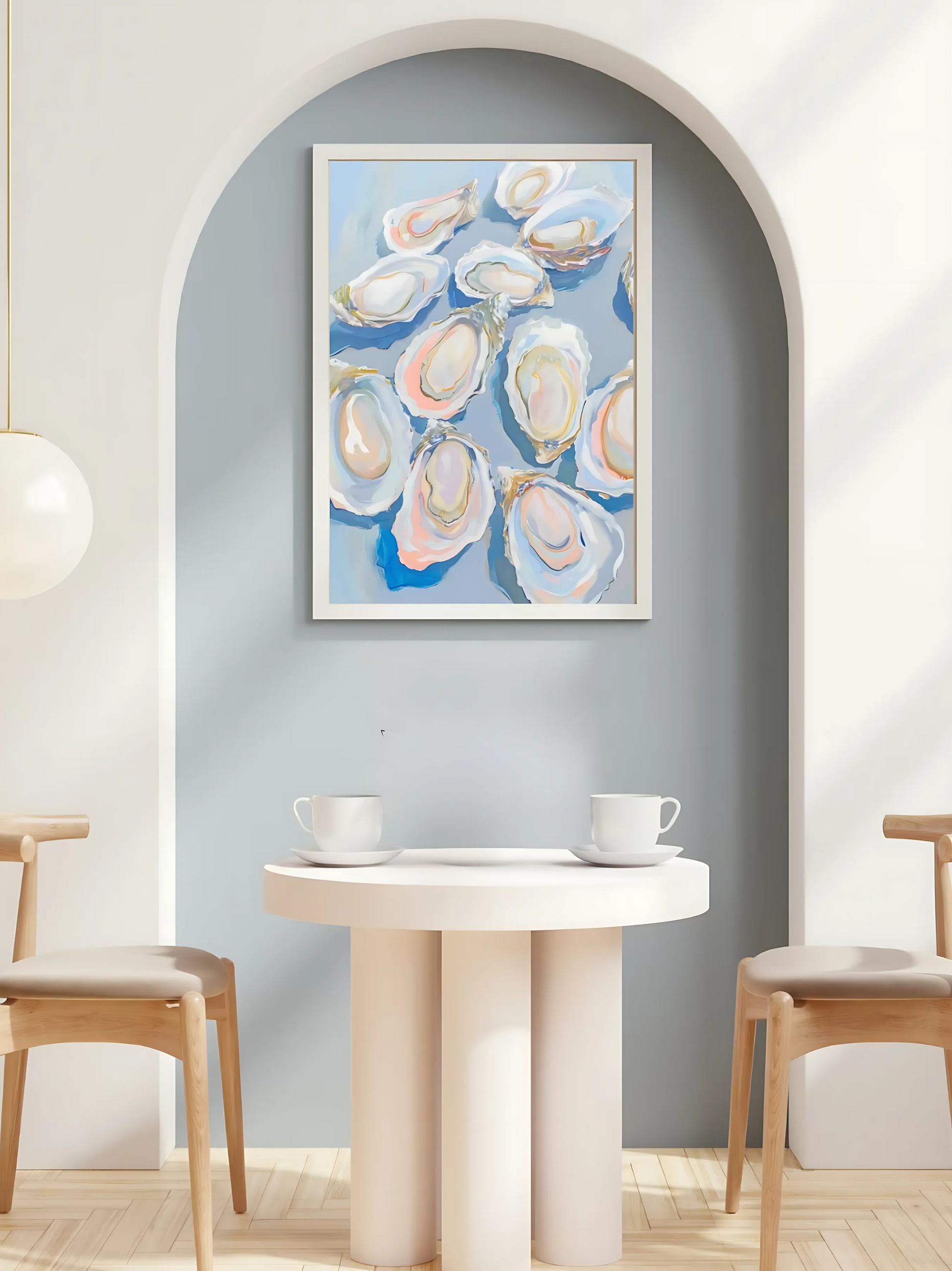 Framed artwork of oyster shells on a wall above a dining table with chairs.