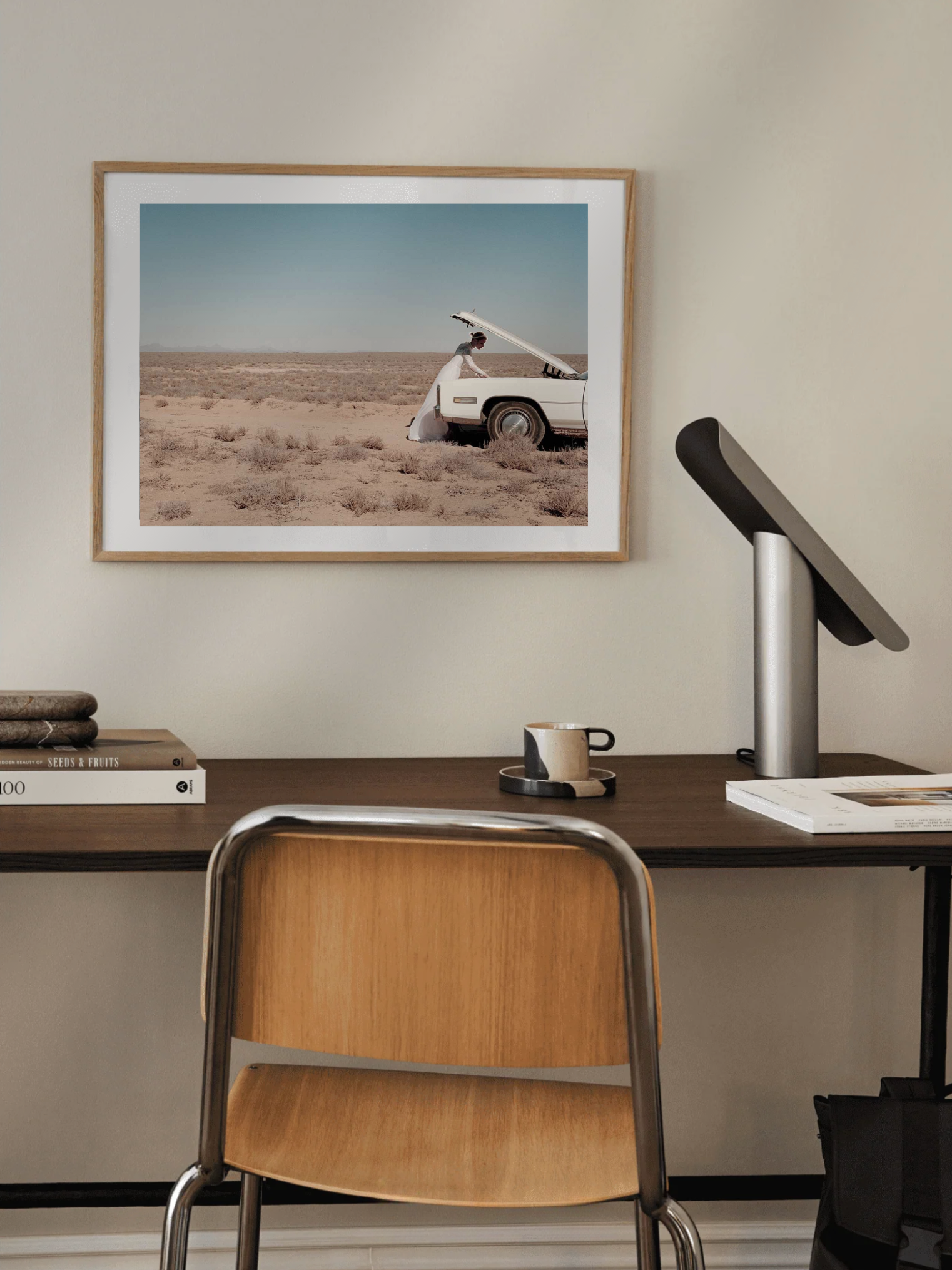 Desk with chair, framed photograph of a Runaway Bride art print with attitude and lamp.